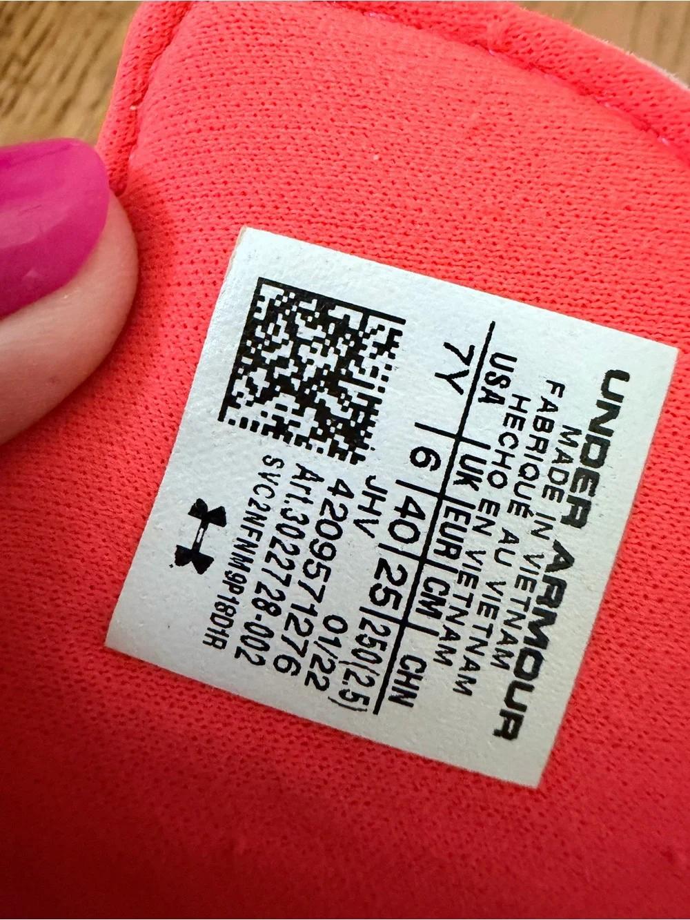 Under Armour Ignite VI coral and black slides with pink and blue accents sandals